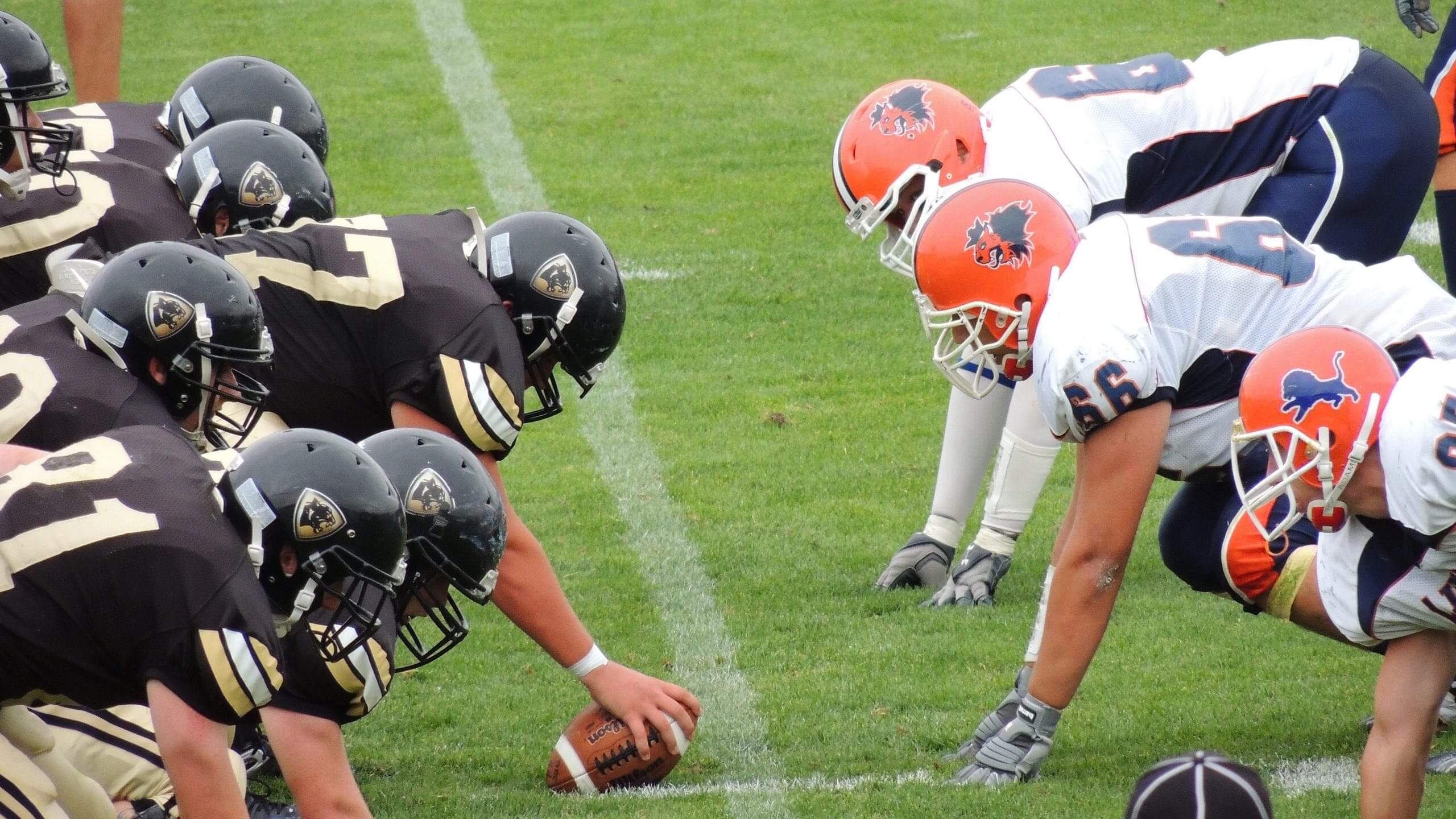 Football players ready to start a play.