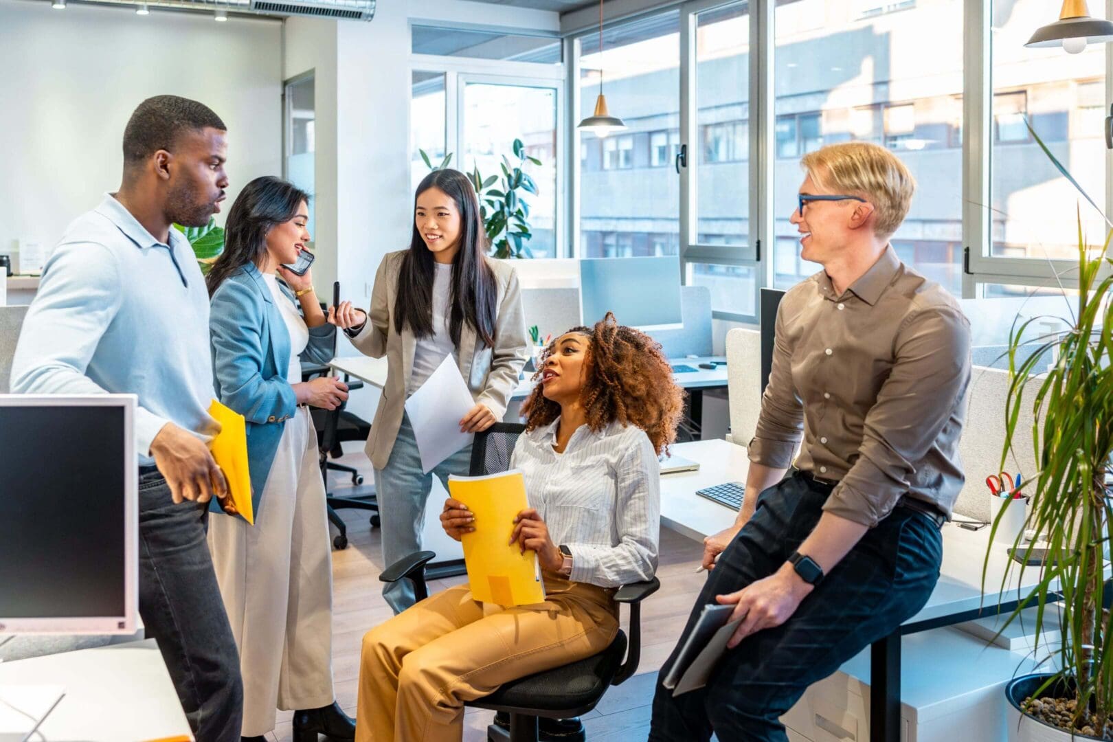 Office team discussing in a bright workspace.