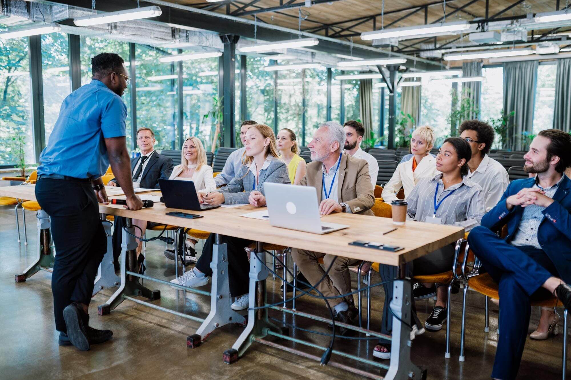 Business presentation with diverse audience in office.