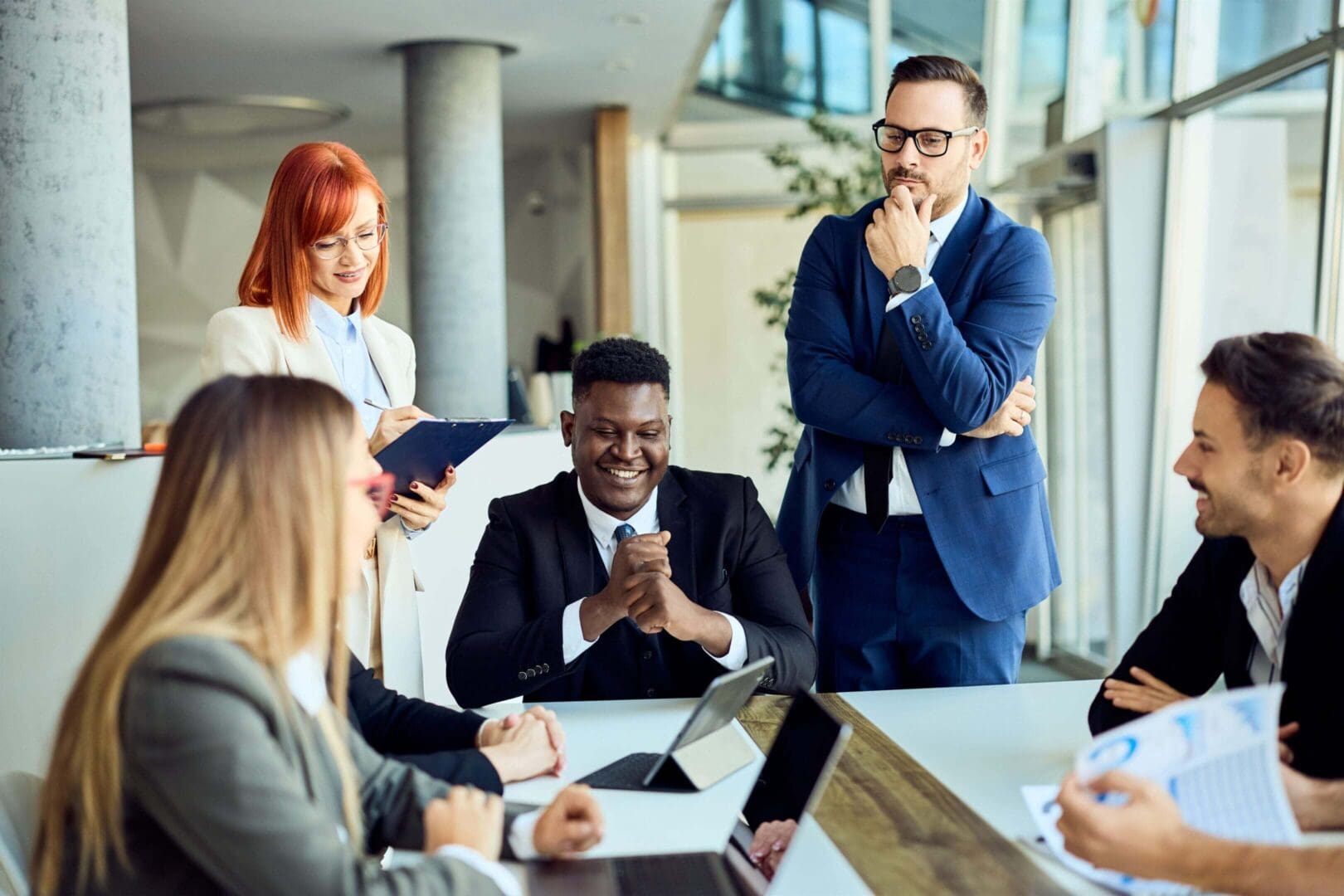 Colleagues discussing and brainstorming ideas in a corporate office environment.
