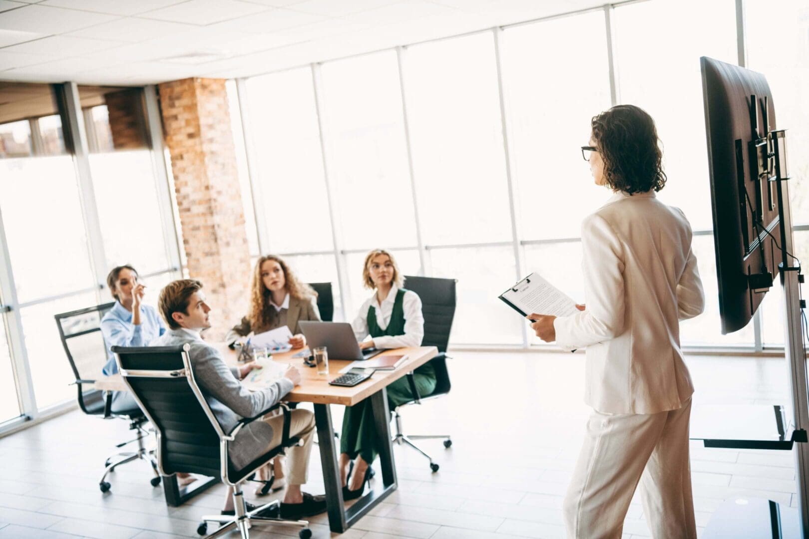 Business meeting presentation in modern office.