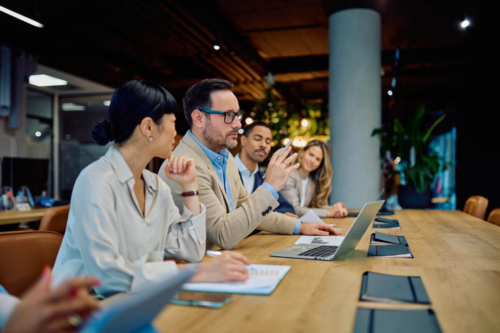 Business professionals engaging in a meeting, discussing strategy and ideas, reflecting teamwork and communication in the office