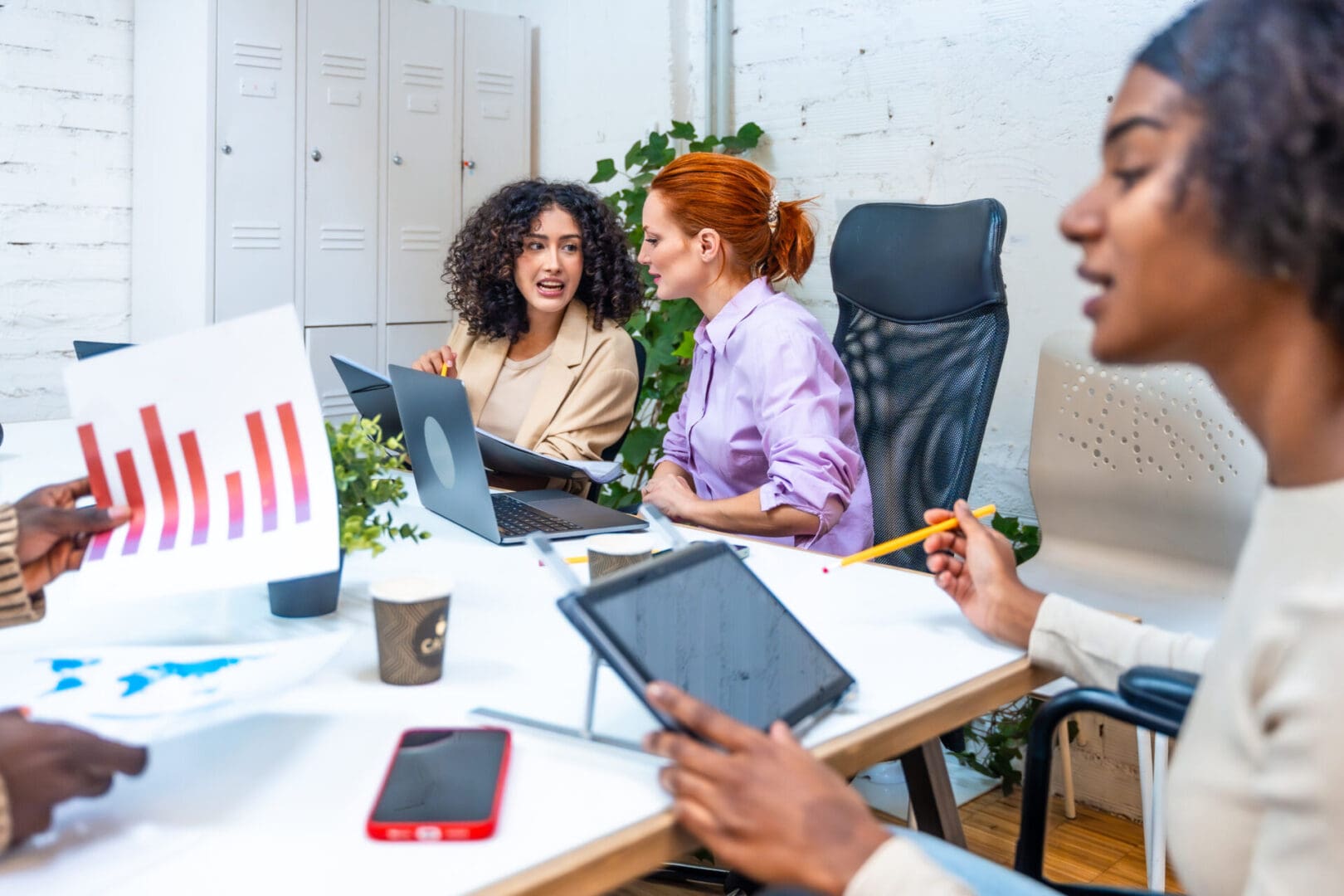 Young diverse and multiracial people working in coworking space analyzing data