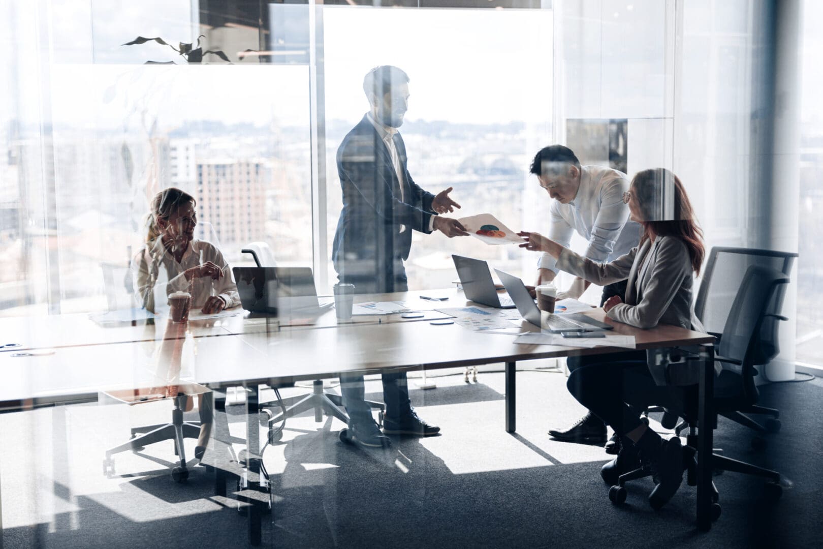 Creative business people working on project in modern office with panoramic view. Teamwork concept