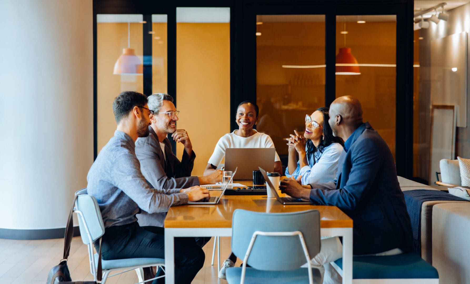 A diverse group of professionals sharing ideas in an office environment during a meeting.