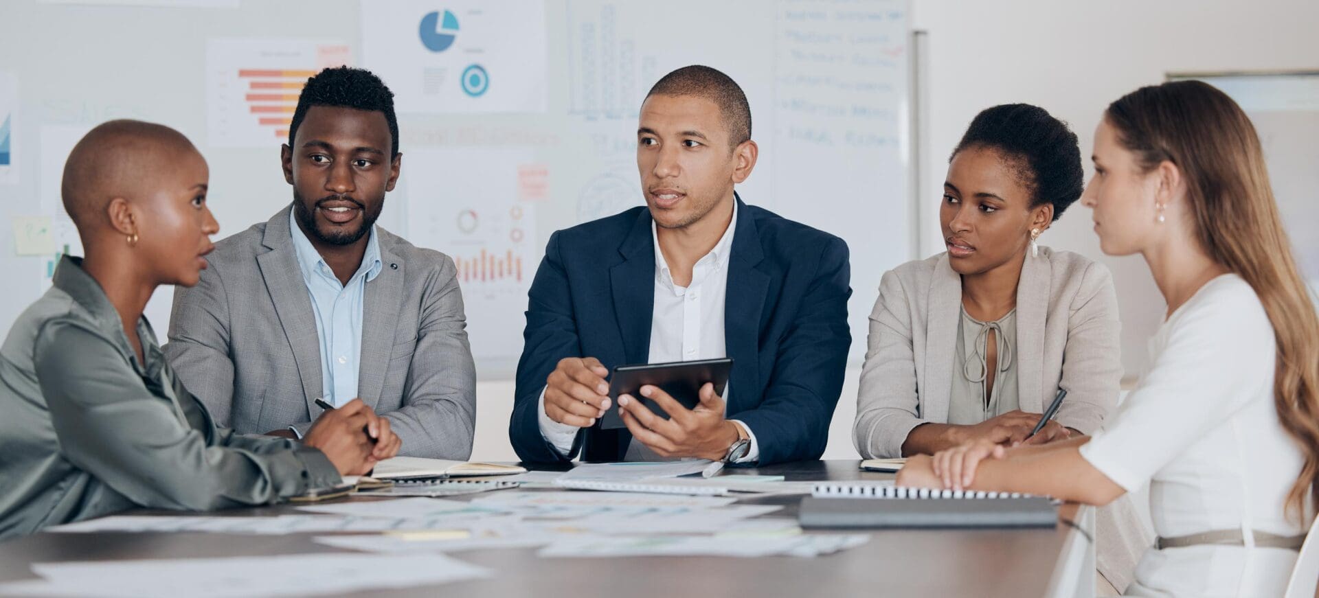 Leadership, planning and talking about ideas with marketing, advertising or finance team using tablet in corporate office. Business people together for collaboration, teamwork and project management