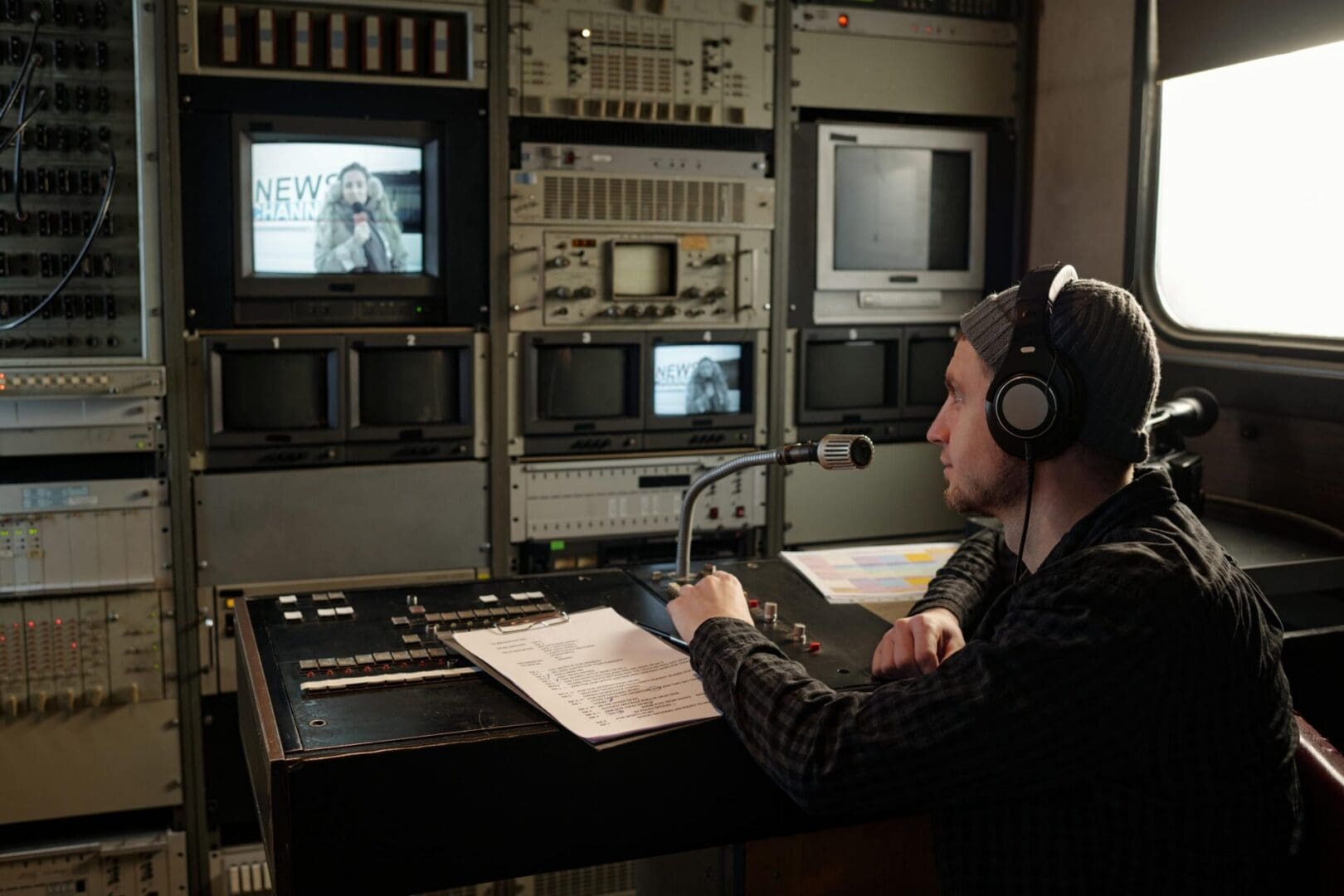Man with headphones in TV control room