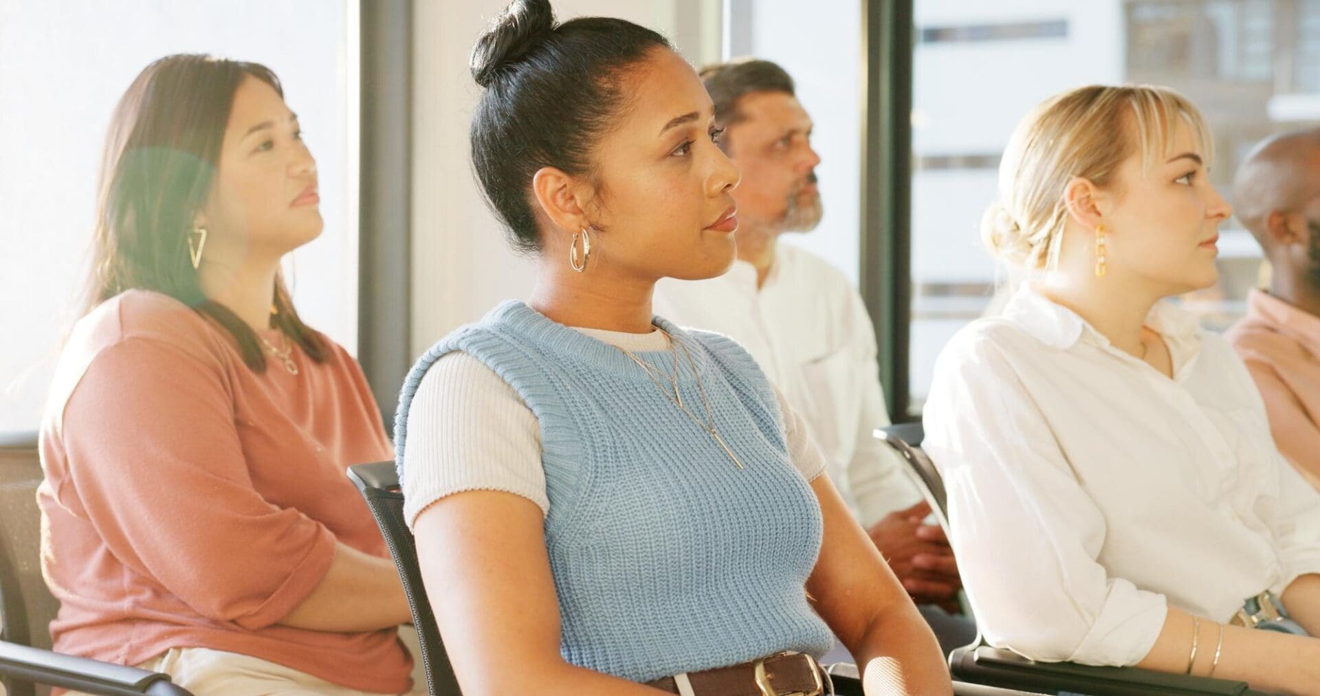 Adults attentively listening in a seminar