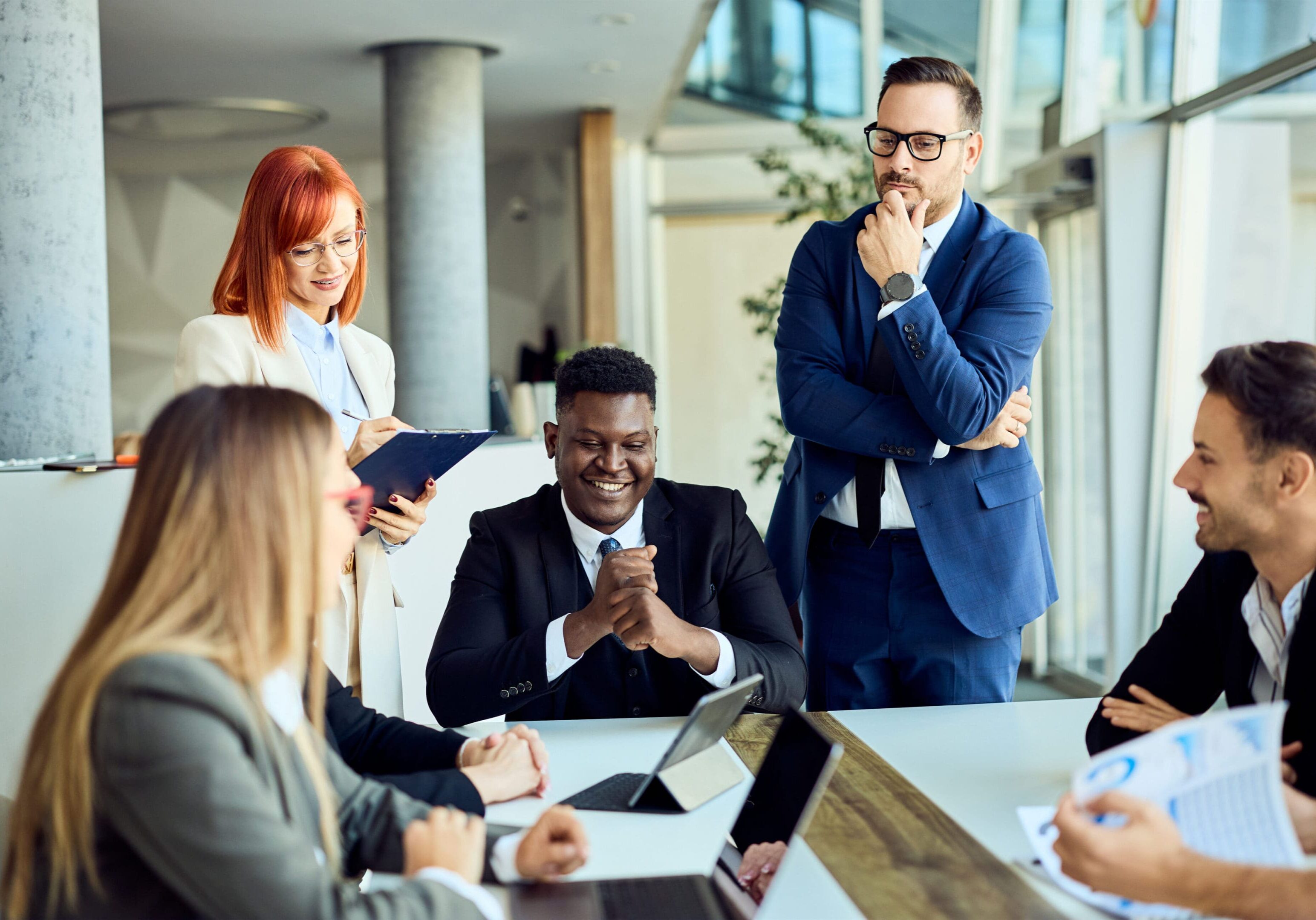 Colleagues discussing and brainstorming ideas in a corporate office environment.