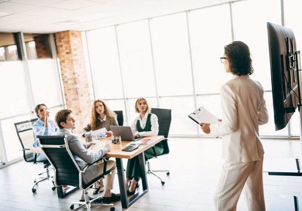 Business meeting presentation in modern office.