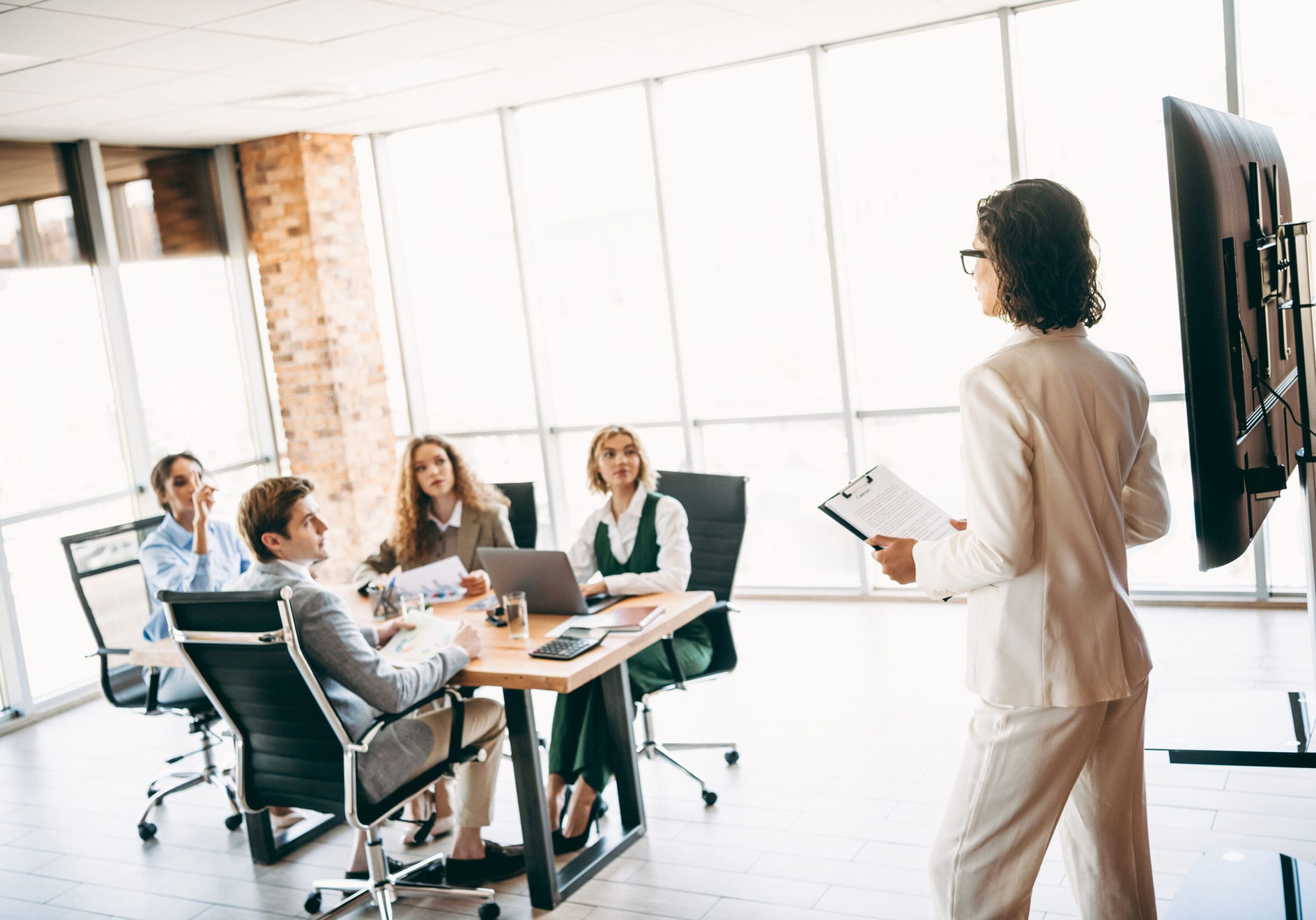 Business meeting presentation in modern office.