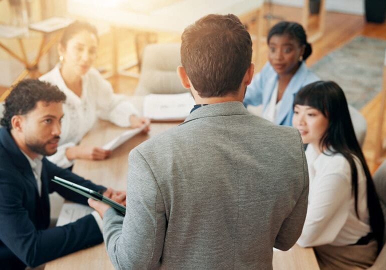 Meeting presentation with diverse team members.