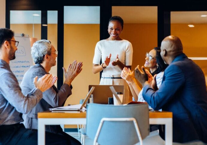 People applauding during a business meeting.