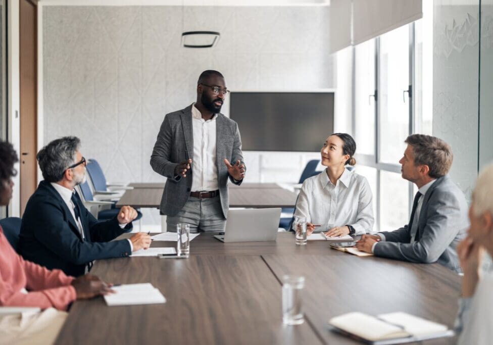 Business meeting with diverse group discussing.