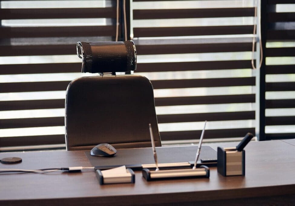 Office desk with chair and stationery.