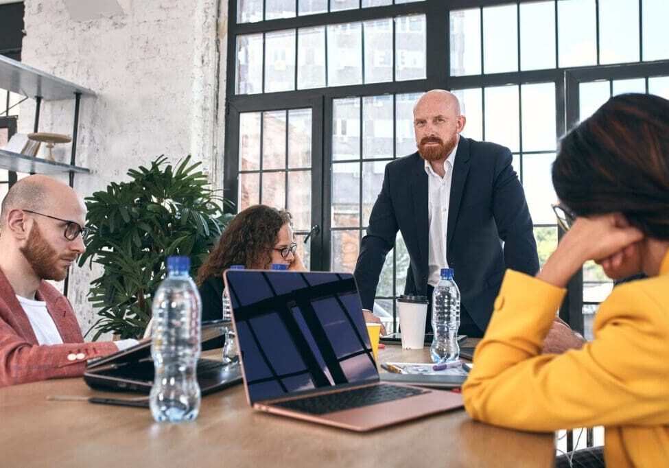 Business meeting with people and laptops.