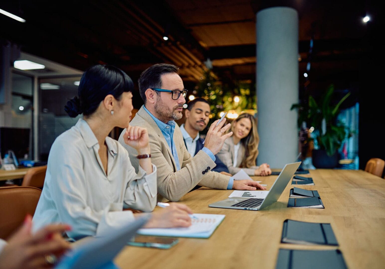 Business professionals engaging in a meeting, discussing strategy and ideas, reflecting teamwork and communication in the office