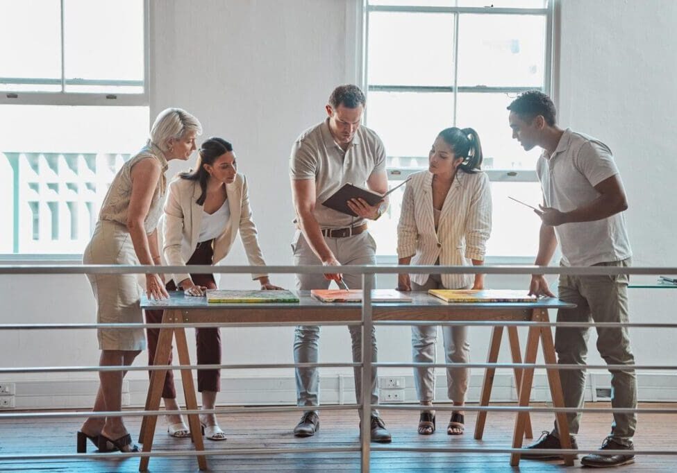 Group collaborating around a table in office.