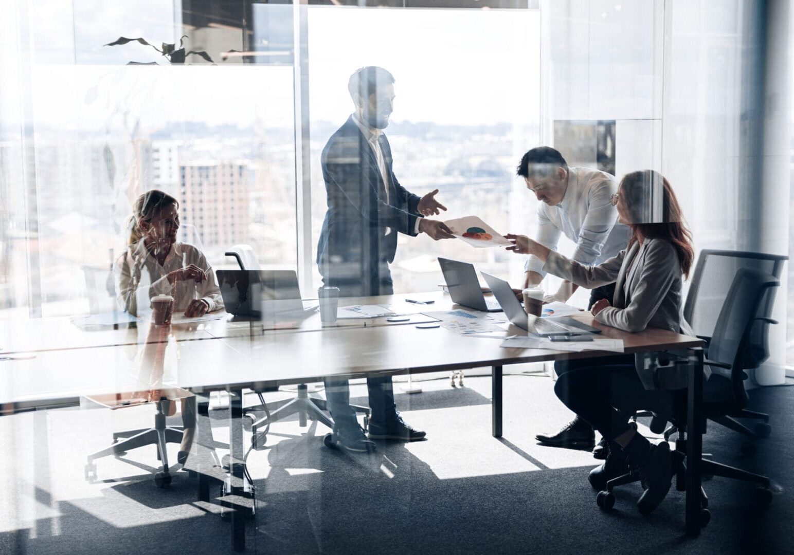 Creative business people working on project in modern office with panoramic view. Teamwork concept