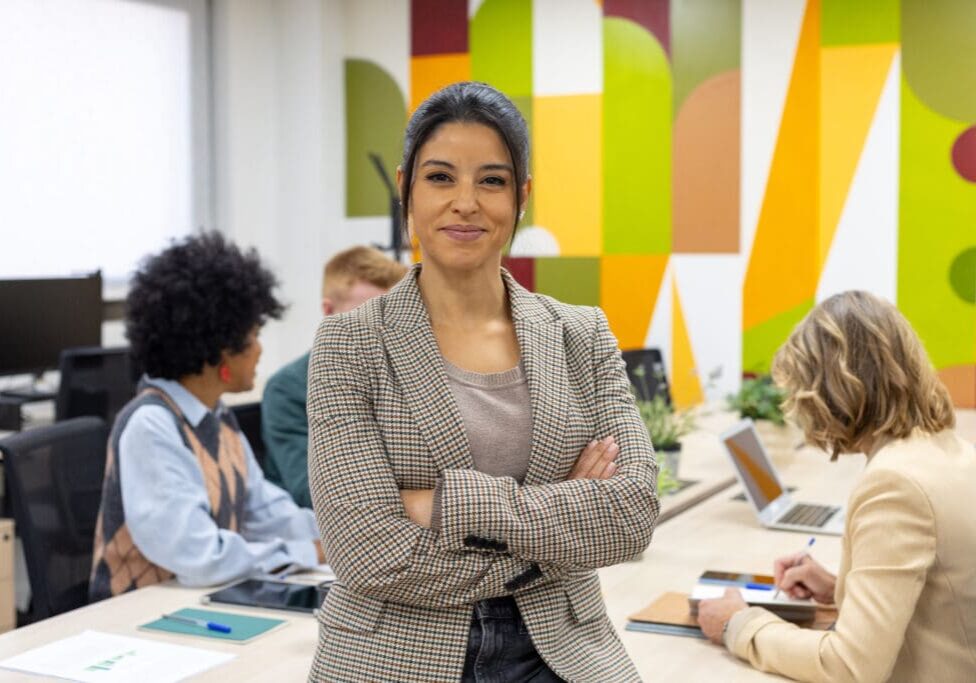 Confident woman in modern office setting.