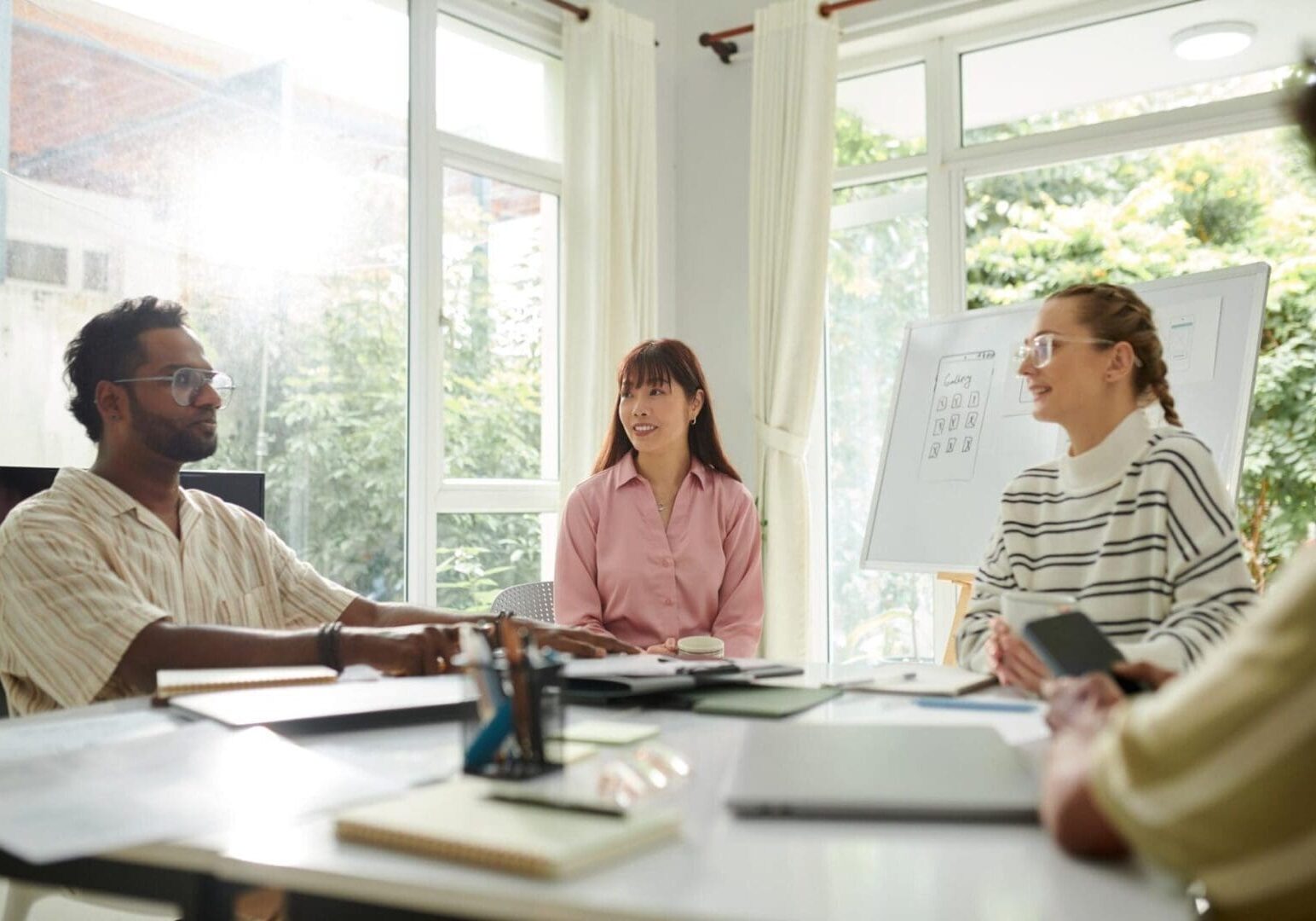 Group meeting in a bright office room.