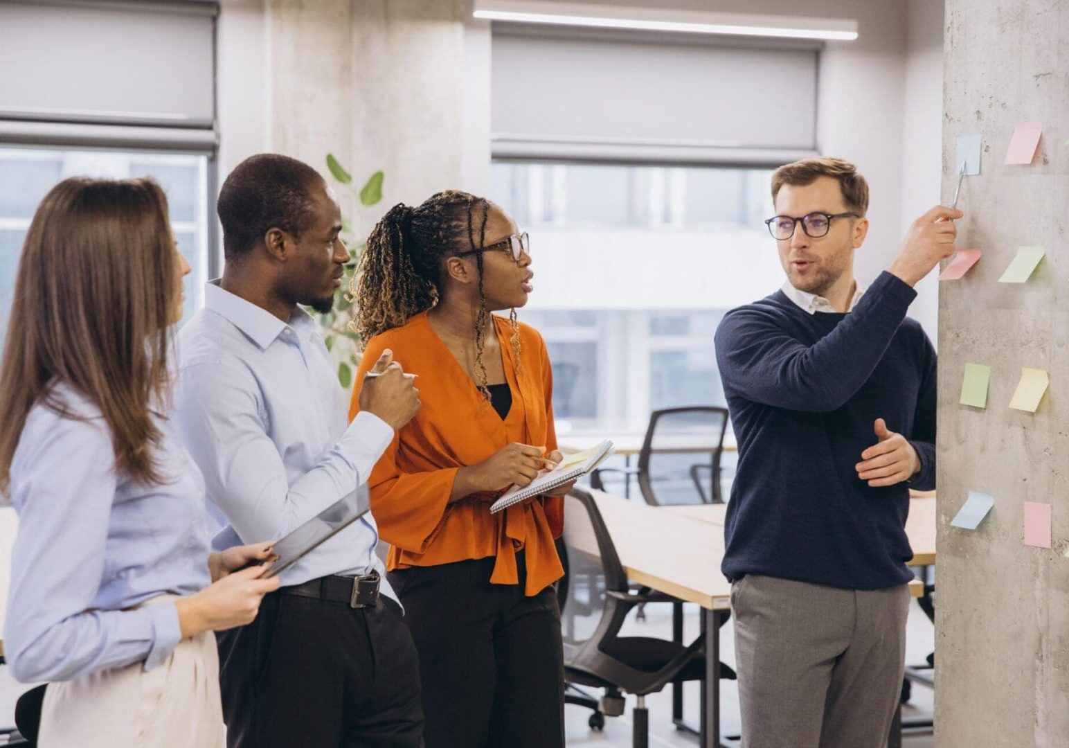 Multi ethnic business team concentrating during a collaboration meeting, discussing startup ideas and project management