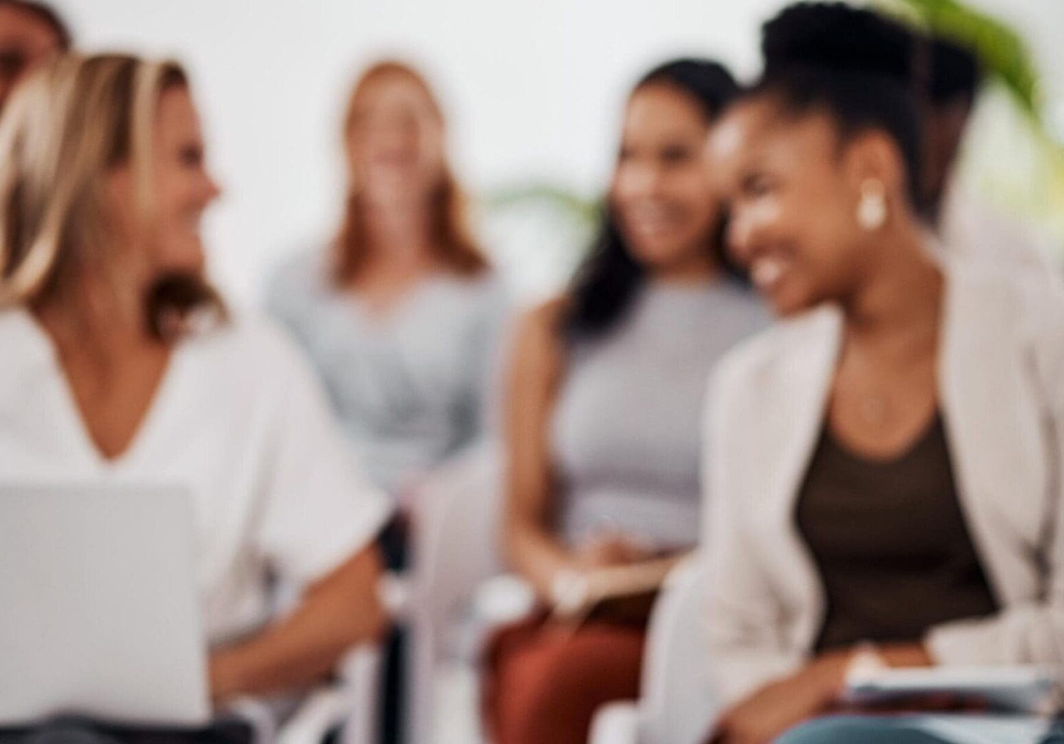 Blurred group of women smiling in meeting