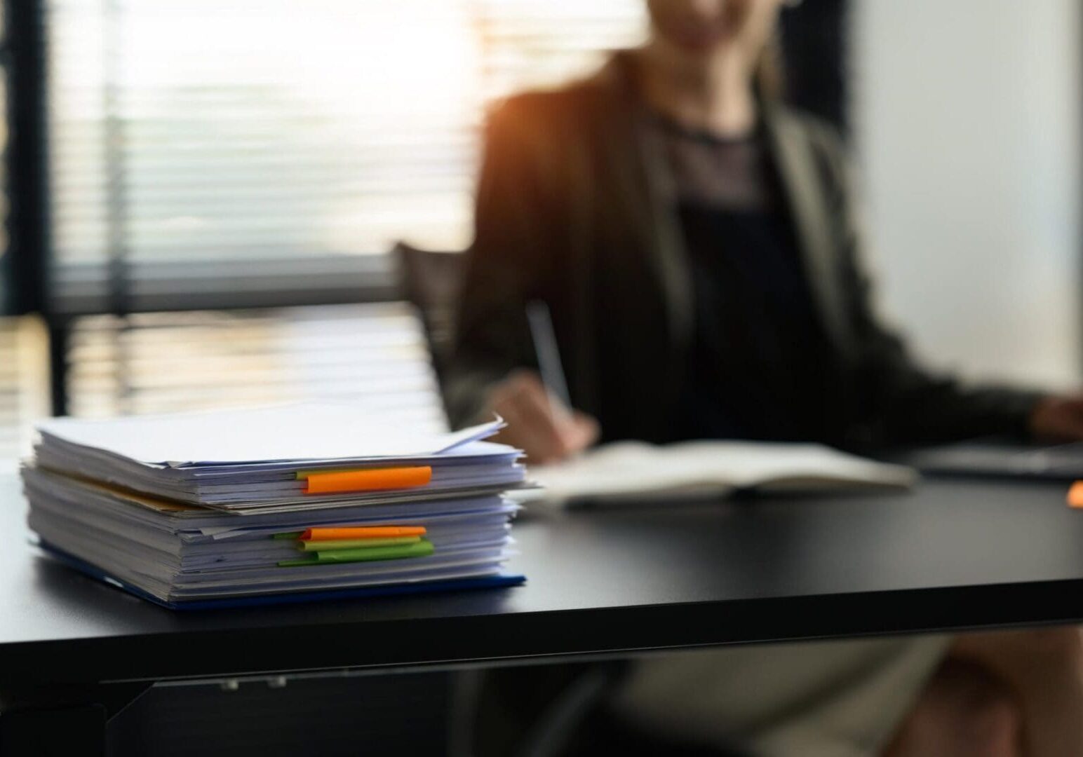 Stack of papers with colorful tabs on desk