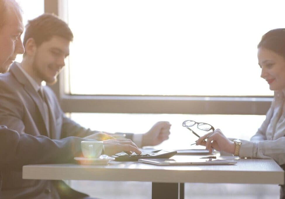 Business colleagues meeting with calculator and glasses