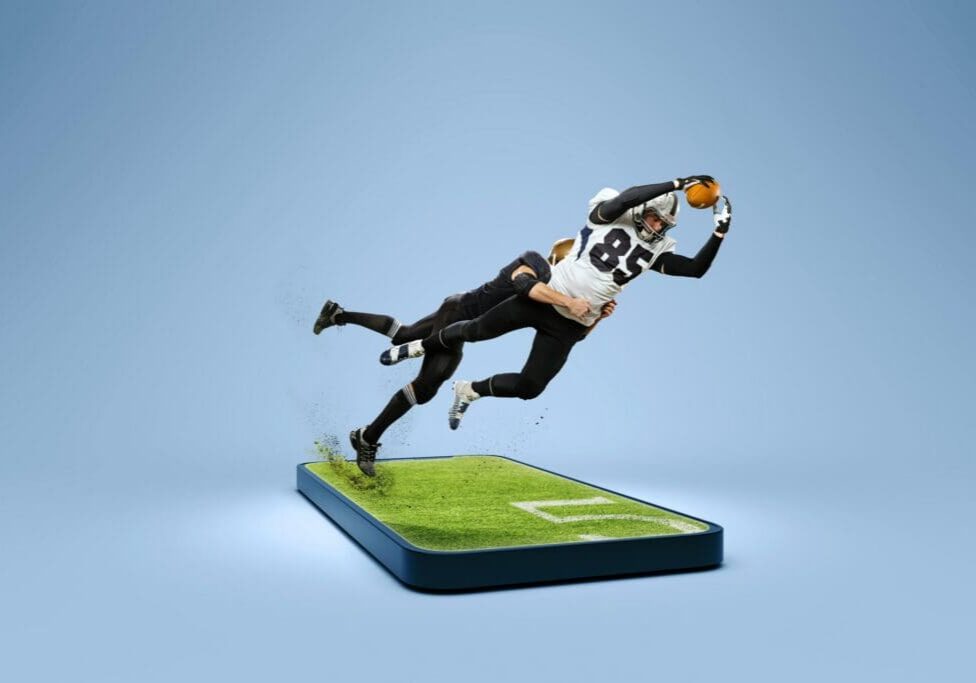 Football players leaping out of smartphone field