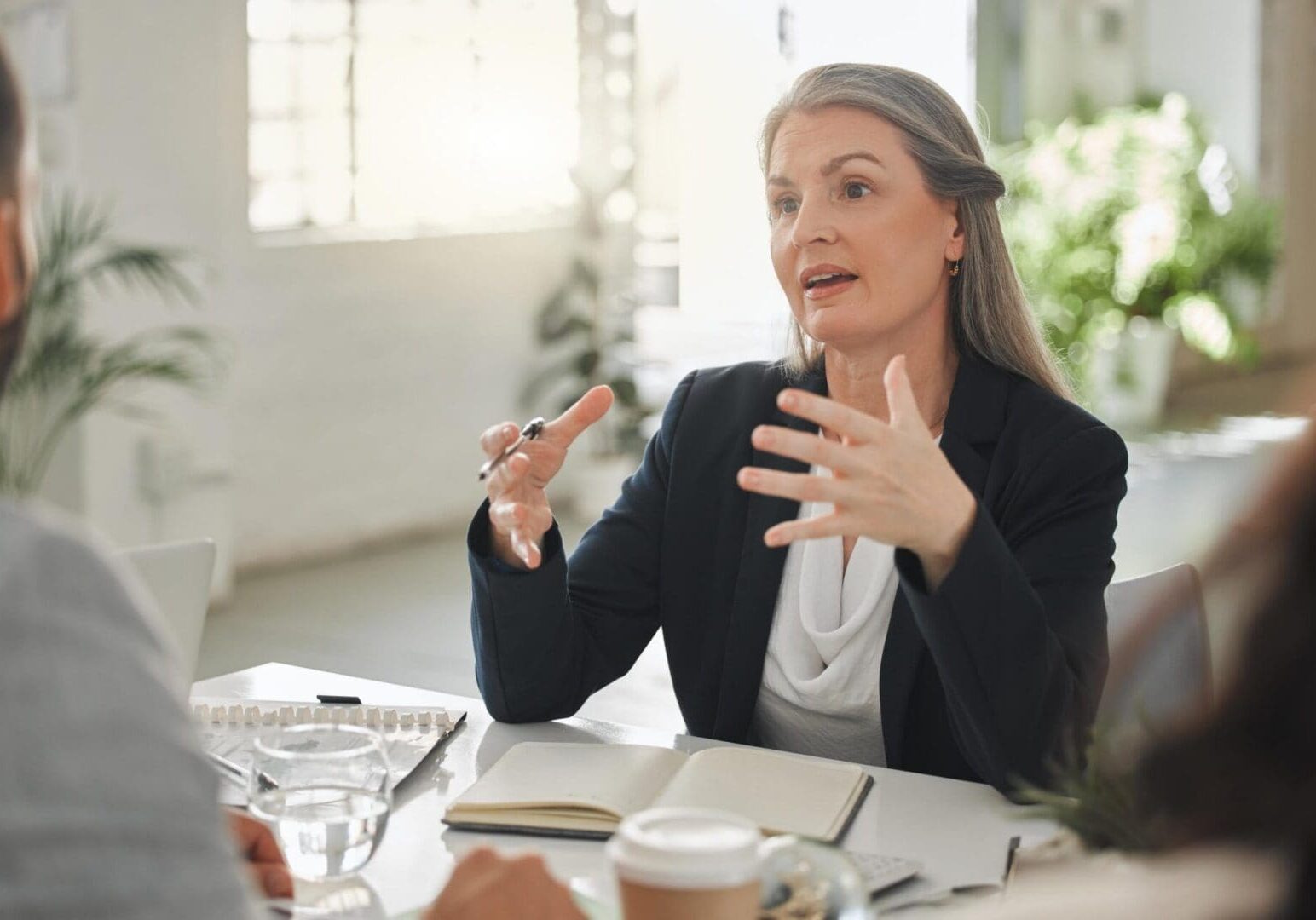 Woman gesturing while speaking in meeting