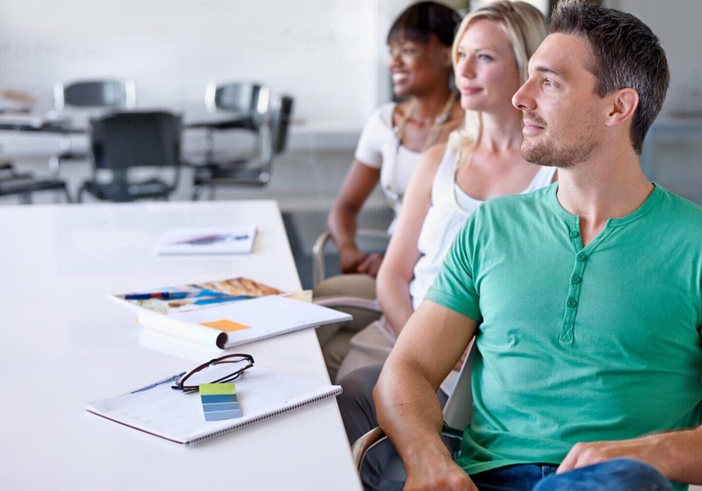 Adults seated at table attentively listening