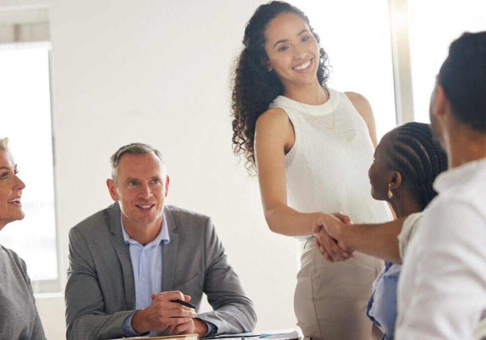 Woman shaking hands in business meeting