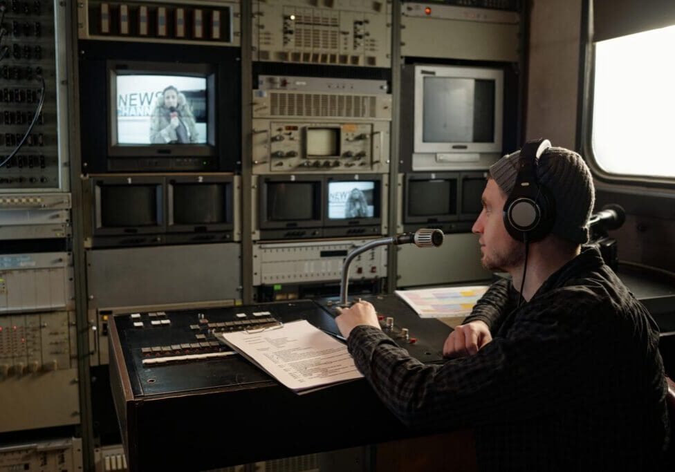 Man with headphones in TV control room