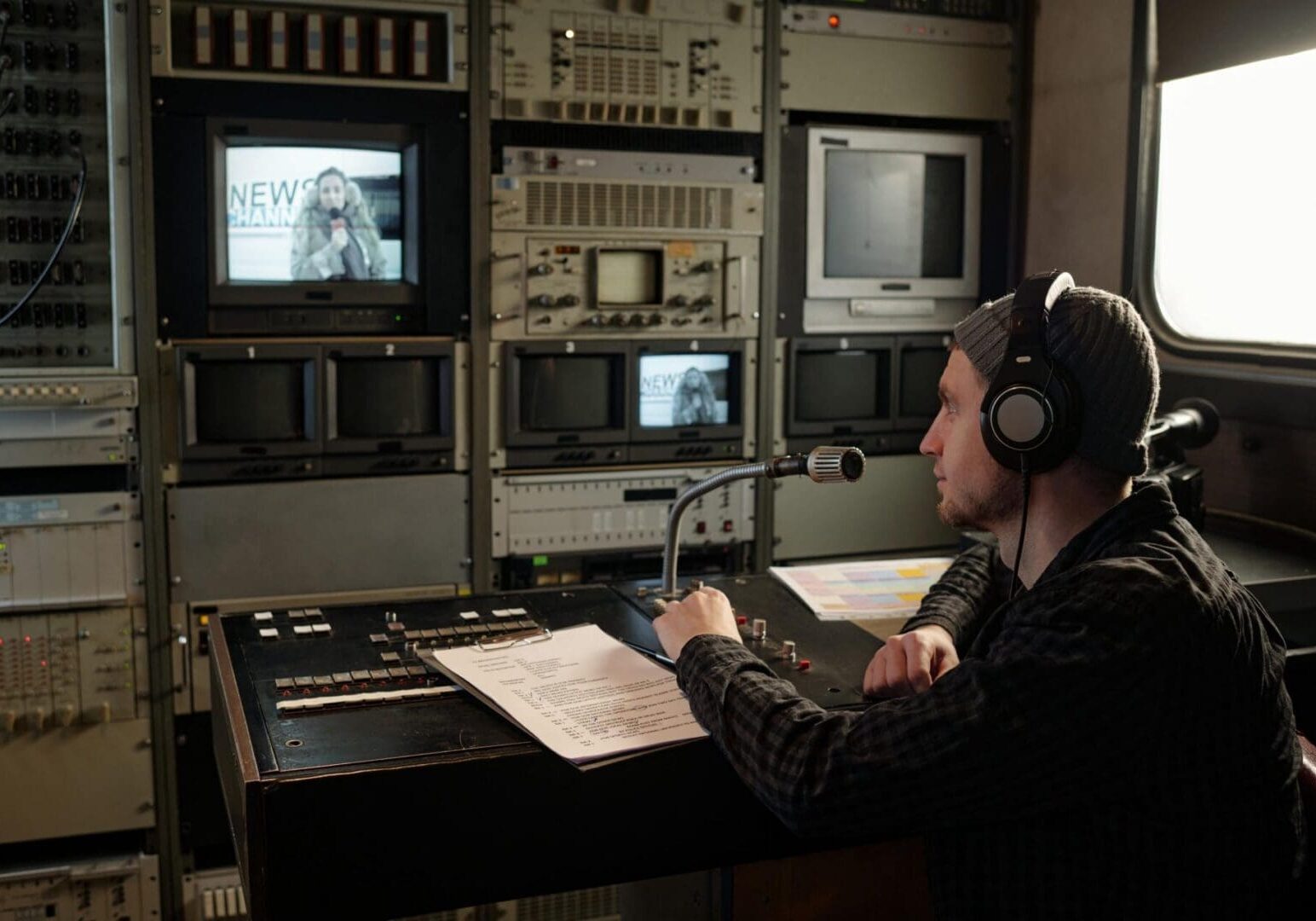Man with headphones in TV control room