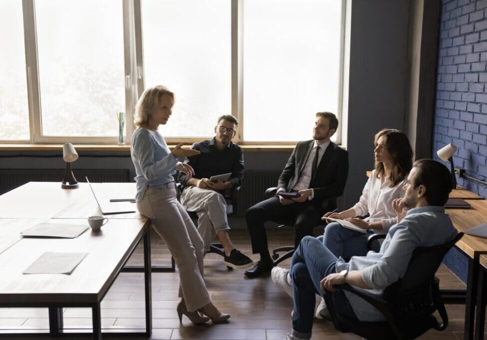 Woman leading small team meeting in office