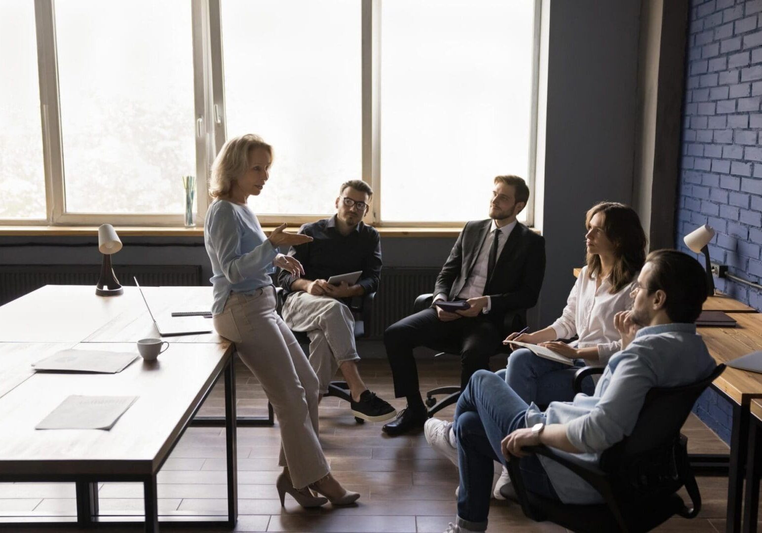 Woman leading small team meeting in office