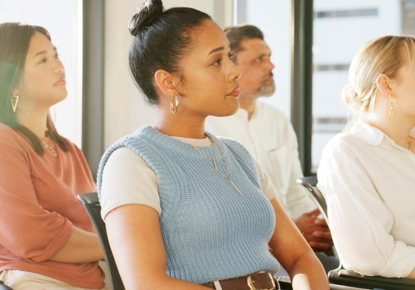 Adults attentively listening in a seminar