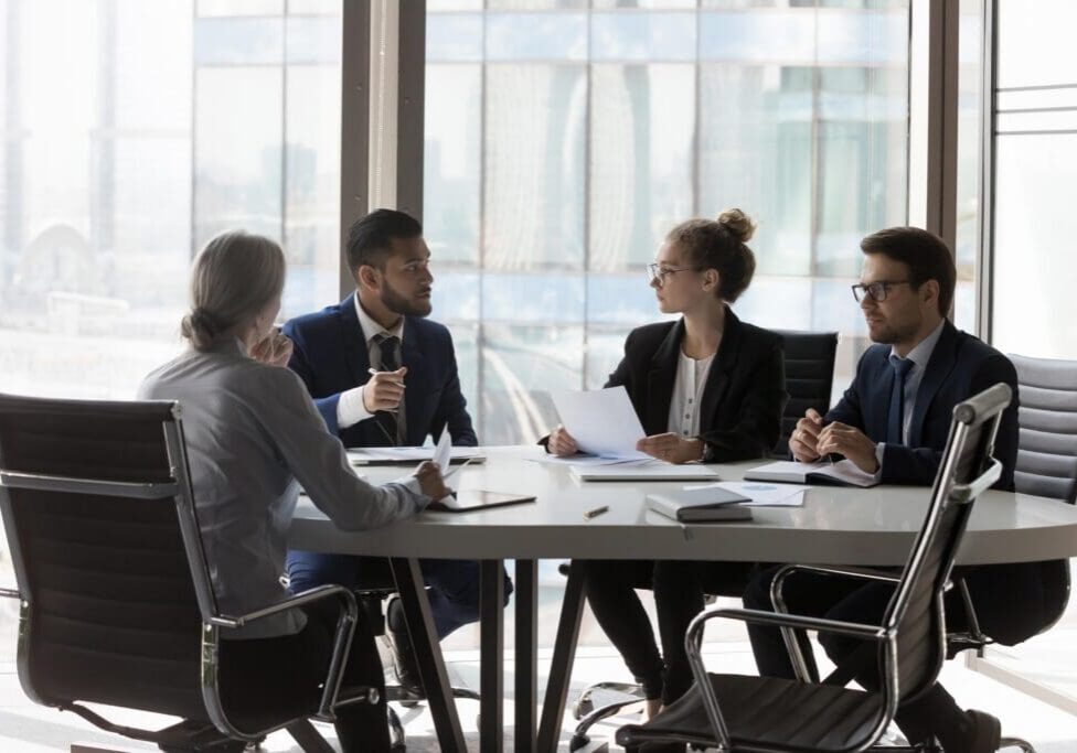 Four professionals in a business meeting