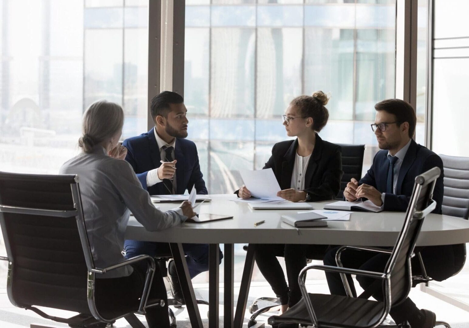 Four professionals in a business meeting