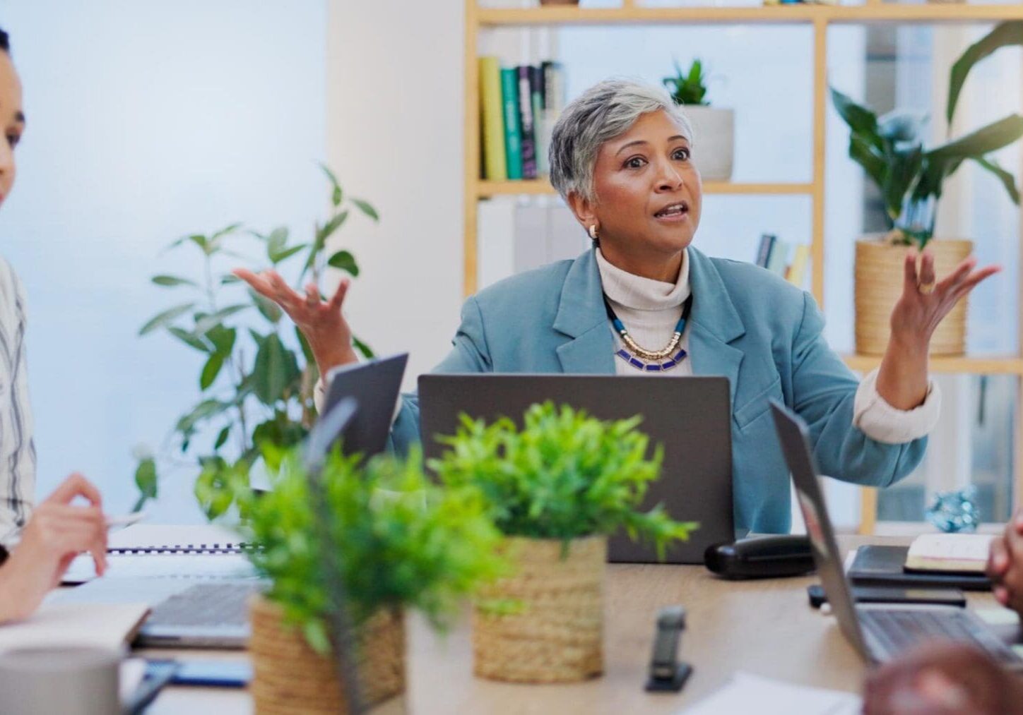Woman gesturing passionately during office meeting