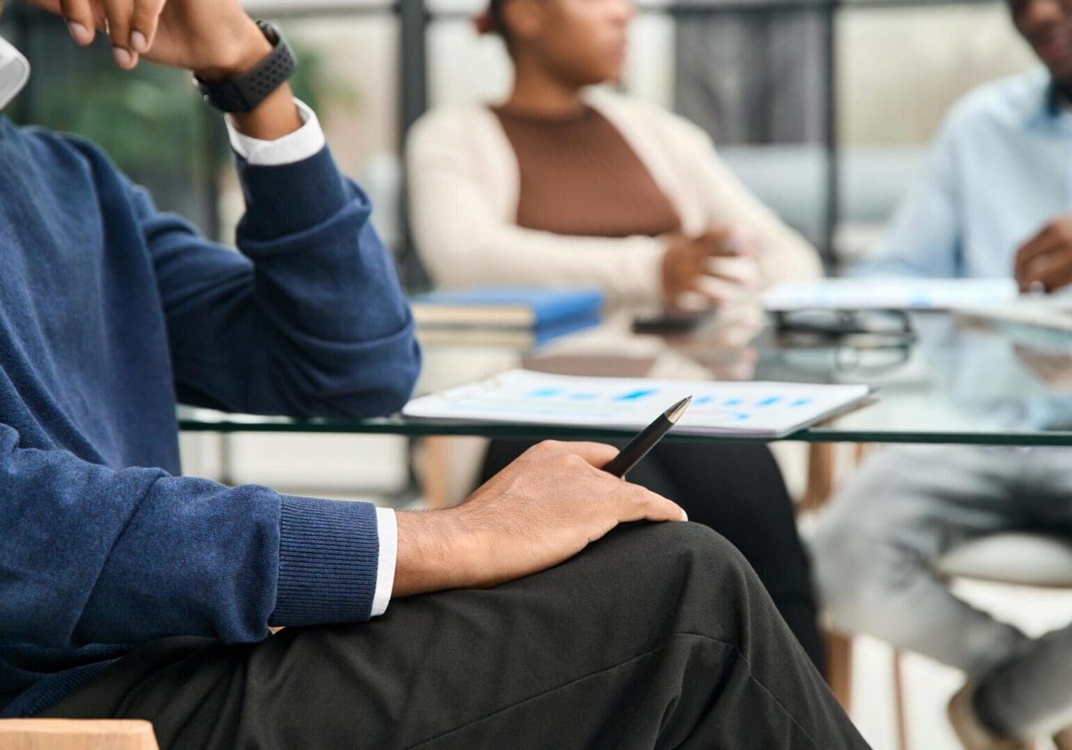 Person holding pen during business meeting
