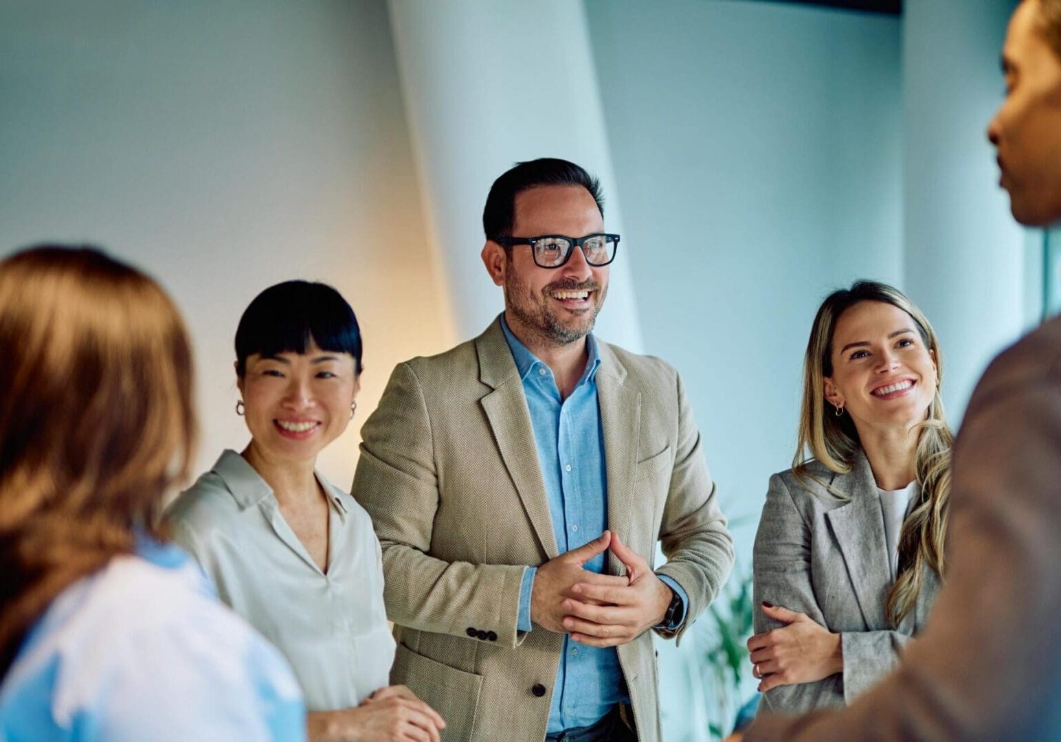 Smiling colleagues chatting in office meeting