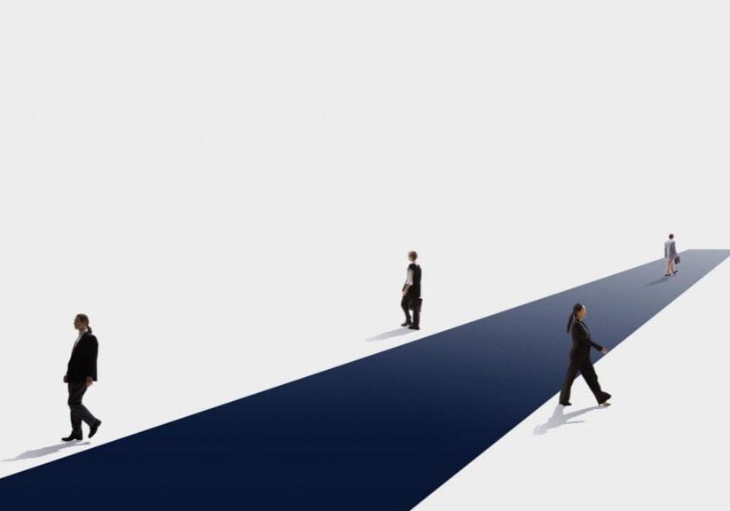 Four professionals walking on navy diagonal path
