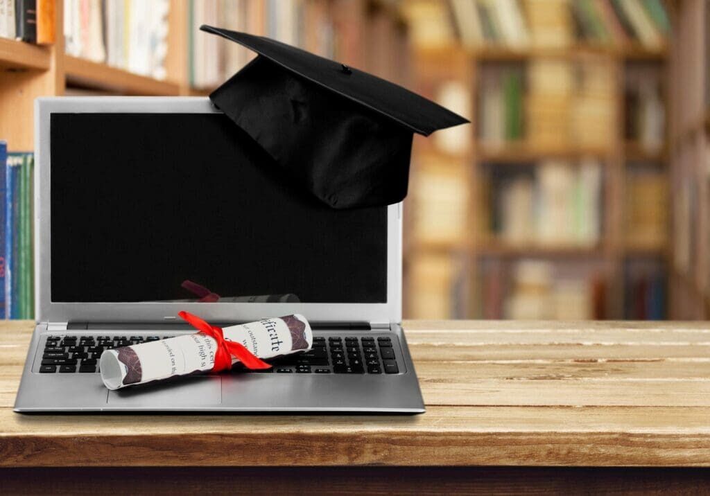 Laptop with graduation cap and diploma