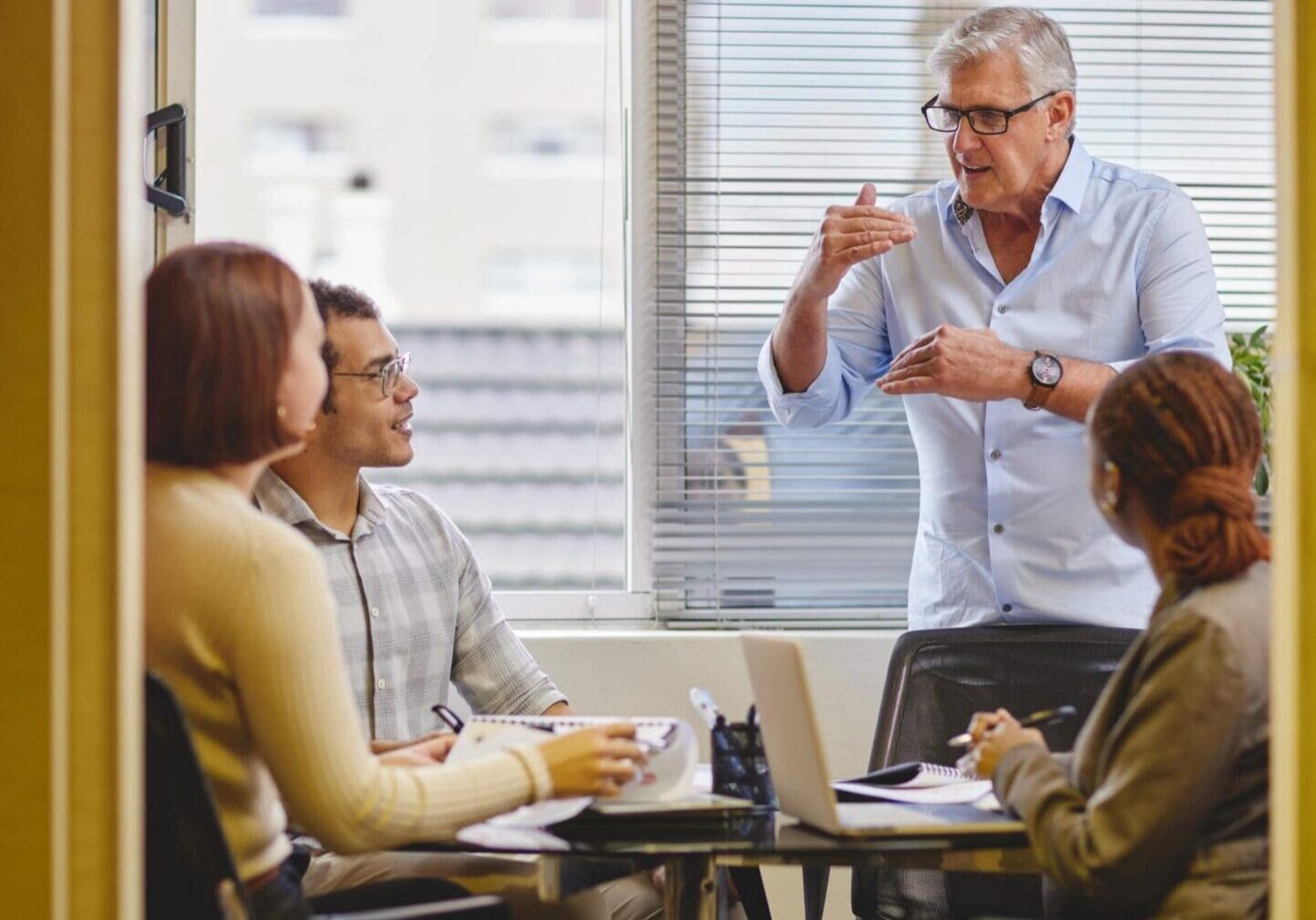 Manager leading small team meeting in office