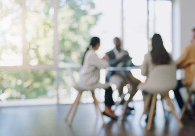 Blurry business meeting in bright office
