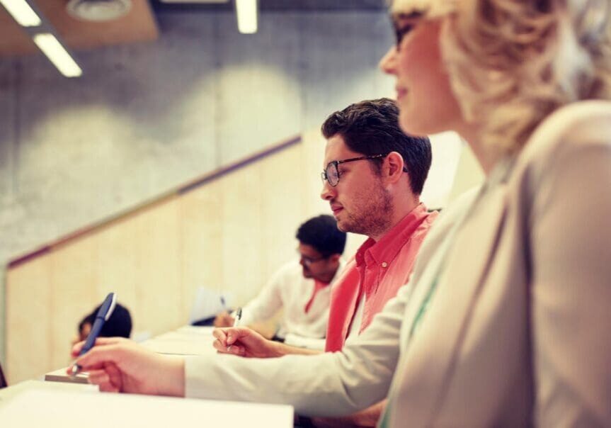 Students taking notes in lecture hall