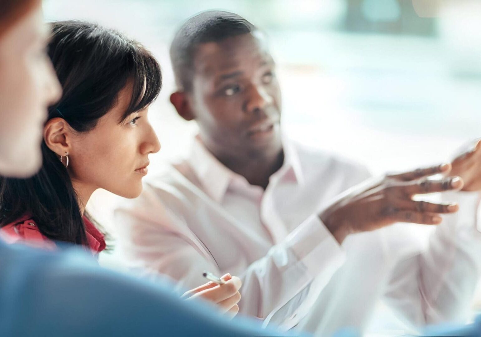 Colleagues discussing project during meeting