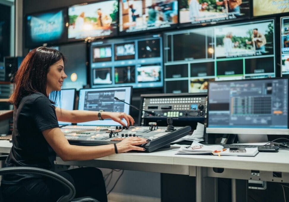 Person operating video switcher in control room